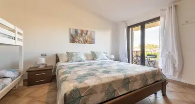 Letto o letti in una camera di CASA PIUMA Castiadas