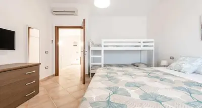 Letto o letti in una camera di CASA PIUMA Castiadas