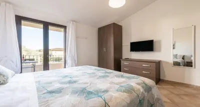 Letto o letti in una camera di CASA PIUMA Castiadas