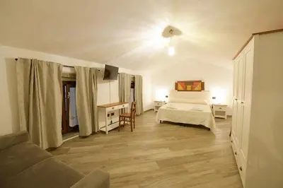 Letto o letti in una camera di Casa Vacanze Nonno Antioco - USO ESCLUSIVO