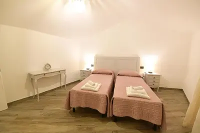 Letto o letti in una camera di Casa Vacanze Nonno Antioco - USO ESCLUSIVO