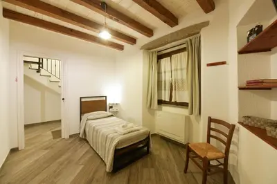 Letto o letti in una camera di Casa Vacanze Nonno Antioco - USO ESCLUSIVO