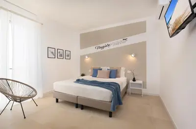 Letto o letti in una camera di Sve Suites Cagliari