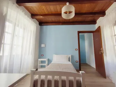 Letto o letti in una camera di Donna Raffaela
