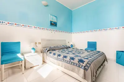 Letto o letti in una camera di GuestHost - La Collina Villasimius - Yellow Apartment!