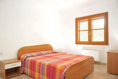 Letto o letti in una camera di Le Peonie 1 - appartamento mare Sardegna