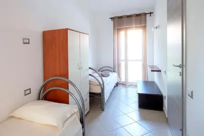 Letto o letti in una camera di Casa Kody a 500 mt dalla spiaggia di Geremeas