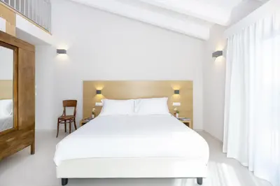 Letto o letti in una camera di Ros'e Mari Green Home Hotel