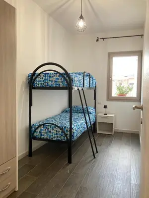 Letto o letti in una camera di WellHouse Sant'Antioco - Relax e comfort a pochi minuti dalle spiagge