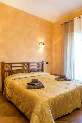 Letto o letti in una camera di Casa Mimosa - Gonnesa