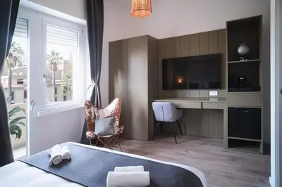 Letto o letti in una camera di New Elegance Suites Guesthouse