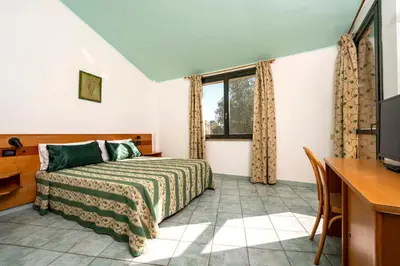 Letto o letti in una camera di Hotel with swimming-pool in Arborea just 600 meters from the sea