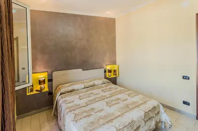 Letto o letti in una camera di B&B nel cuore di Loceri