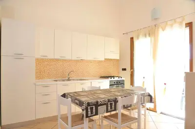Cucina o angolo cottura di I Pini - appartamento mare Sardegna