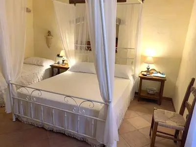 Letto o letti in una camera di B &B Inn - COME UN PICCOLO HOTEL- CAMERE CON BAGNO PRIVATO-PARCHEGGIO INTERNO PER MOTO e BICI -ENERGETIC BREAKFAST extra
