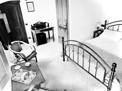 Letto o letti in una camera di B &B Inn - COME UN PICCOLO HOTEL- CAMERE CON BAGNO PRIVATO-PARCHEGGIO INTERNO PER MOTO e BICI -ENERGETIC BREAKFAST extra