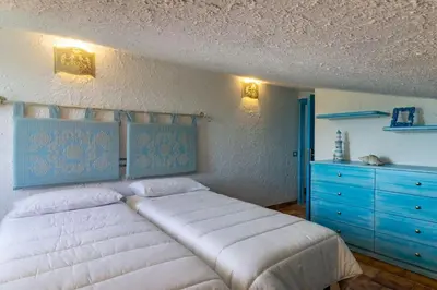 Letto o letti in una camera di Villa Mario & Anna Carloforte