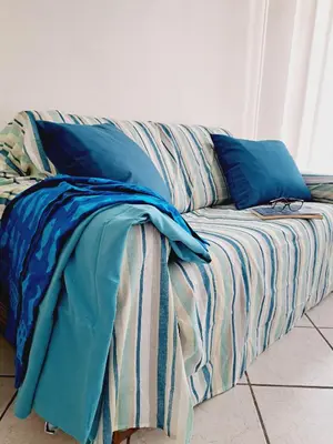 Letto o letti in una camera di Casa Picasso Luminoso appartamento 2 camere a Cagliari