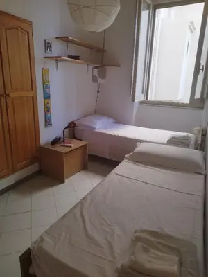 Letto o letti in una camera di Casa Sanna Cagliari