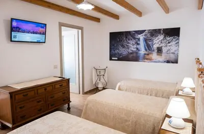 Letto o letti in una camera di B&B Ruinas
