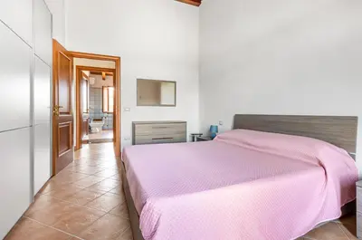 Letto o letti in una camera di GuestHost - Sweet Home in Portoscuso!