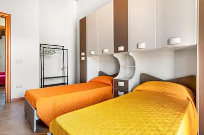 Letto o letti in una camera di GuestHost - Sweet Home in Portoscuso!