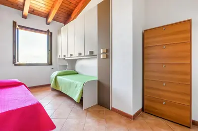 Letto o letti in una camera di GuestHost - Sweet Home in Portoscuso!