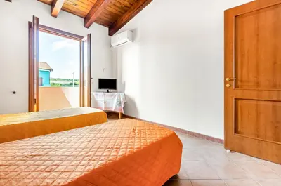 Letto o letti in una camera di GuestHost - Sweet Home in Portoscuso!