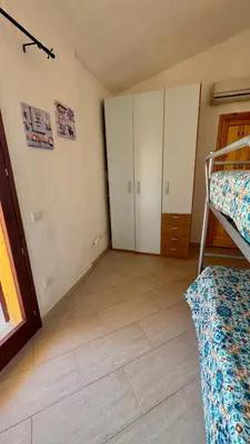 Letto o letti in una camera di Villa Arianna - Porto Pino