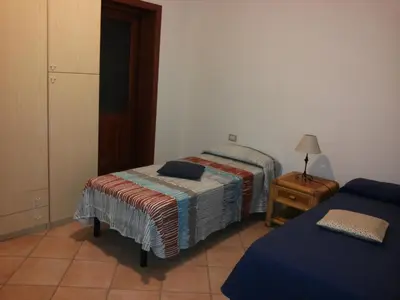 Letto o letti in una camera di Villetta via del mirto