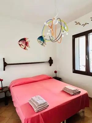 Letto o letti in una camera di Villa Mariella Costa Rei