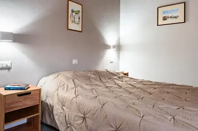 Letto o letti in una camera di L'Ulivo Affittacamere Gonnosfanadiga