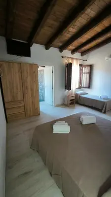 Letto o letti in una camera di L'Ulivo Affittacamere Gonnosfanadiga