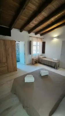 Letto o letti in una camera di L'Ulivo Affittacamere Gonnosfanadiga
