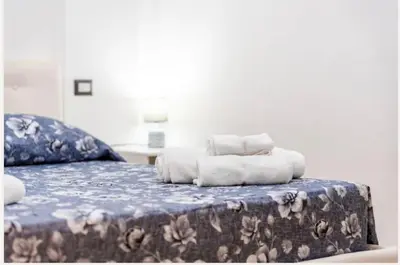 Letto o letti in una camera di Colombo House
