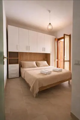 Letto o letti in una camera di Villetta con giardino e Bbq al centro di Villasimius