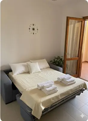Letto o letti in una camera di Villetta con giardino e Bbq al centro di Villasimius