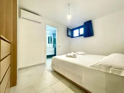 Letto o letti in una camera di La Pergola Apartments