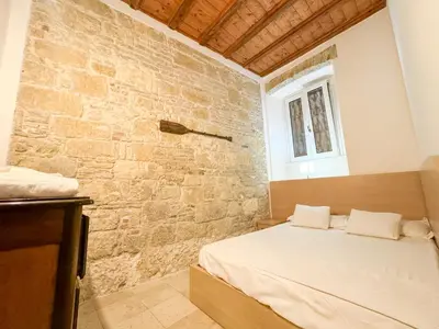 Letto o letti in una camera di Kalma Via Manno - Central Stay with Stone Walls & Private Cinema