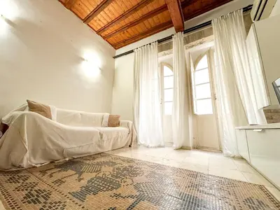 Letto o letti in una camera di Kalma Via Manno - Central Stay with Stone Walls & Private Cinema