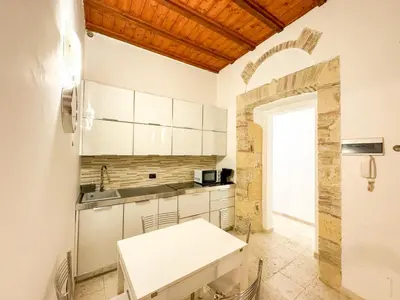 Cucina o angolo cottura di Kalma Via Manno - Central Stay with Stone Walls & Private Cinema