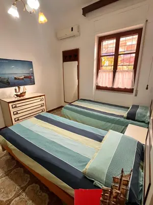 Letto o letti in una camera di Casa dei nonni