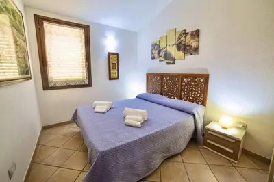 Letto o letti in una camera di Village in Porto Corallo just 200 meters from the beach, apartments with private outdoor area