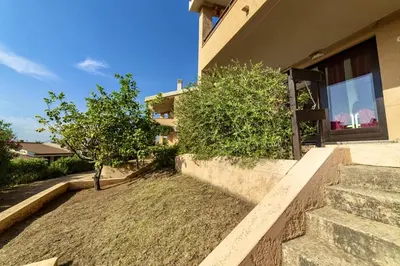 Giardino di ISA-Village in Porto Corallo just 200 meters from the sea, apartments with private outdoor area
