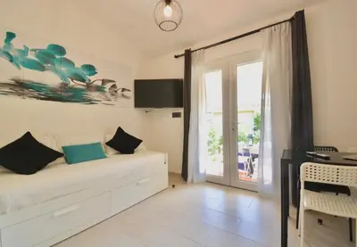 Letto o letti in una camera di Residence in Costa Rei just 450 meters from the beach, apartments with air conditioning and outdoor private area