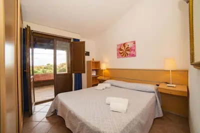 Letto o letti in una camera di Villetta Seaside Sardegna