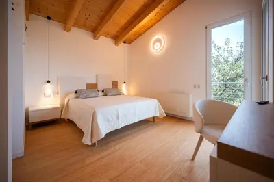 Letto o letti in una camera di Camere in villa da Anna, Poggio dei Pini