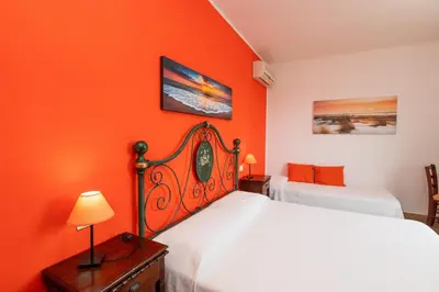 Letto o letti in una camera di B&B L'Asfodelo