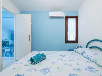 Letto o letti in una camera di Villetta Valentina vista mare Bestvacationever