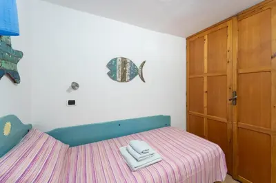 Letto o letti in una camera di Villa degli Angeli - Appartamento Portopinetto